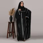 Eraj Abaya in black with white stripes by Al Sanaya, featuring a matching hijab and made from Nidah fabric. Ideal for casual wear.