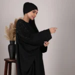 “Ezzah Black Abaya by Al Sanaya with heavy embellishments”