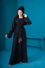 Falak Stone Abaya by Alsanaya – Black Nidah fabric with stone embellishments on cuffs and belt, includes black hijab